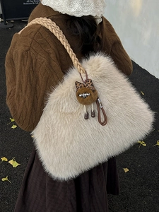 Beige faux fur tote bag with braided rope handle and leopard print plush charm