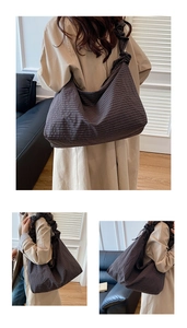 Detail view of large checkered tote bag with pleated shoulder strap and soft fabric texture