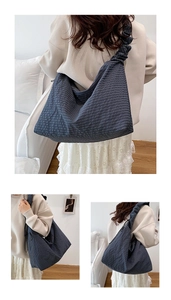 Detailed view of deep blue plaid tote bag with stylish scrunchie-style shoulder straps