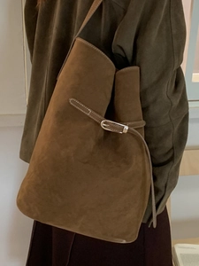 Brown vintage suede bucket bag with white stitching and metal buckle for women