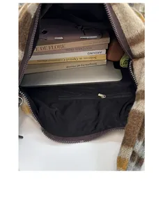 Macro view of large plaid tote bag interior showing spacious storage for laptop and books