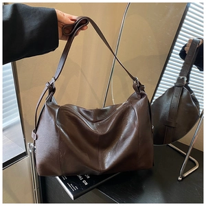 Detail view of the deep brown hobo bag showing soft PU leather and adjustable shoulder strap