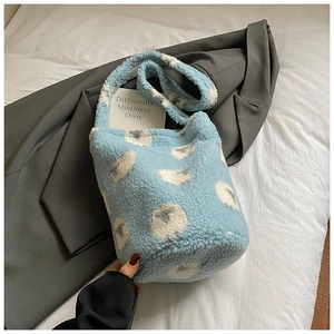 Détail du sac seau bleu clair en sherpa avec motif de nuages sur tissu doux et souple