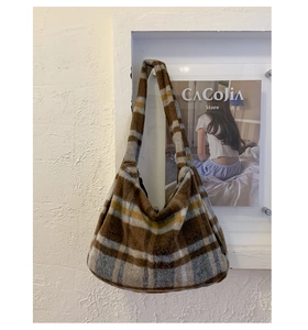 Detailed close-up of retro plaid wool tote bag with soft brown and grey patterns