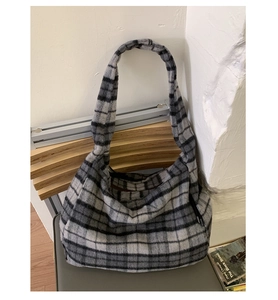 Detail of black and white plaid wool tote bag with textured autumn and winter fabric