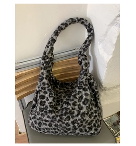 Detail of grey leopard print plush tote bag showing soft faux fur texture and slouchy design