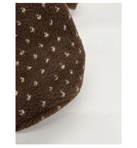 Detail of durable brown faux shearling fabric with white polka dots for tote bag