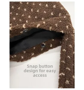 Detail of metal snap button closure and plush brown polka dot tote bag interior