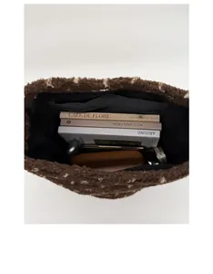 Top view of the spacious brown plush tote bag interior with multiple daily items