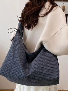 Plaid canvas tote bag in navy and grey with spacious drawstring design for daily use