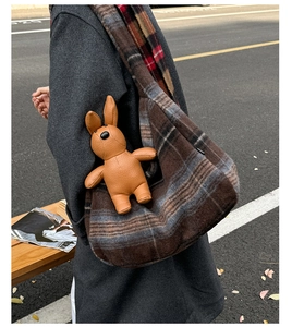 Detail of large check tote bag in dark grey wool with cute brown leather rabbit charm