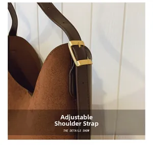 Detail of adjustable leather strap with gold buckle on leopard print bucket bag