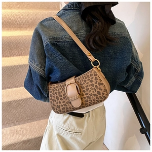 Detail of leopard print shoulder bag with golden hardware and beige leather buckle