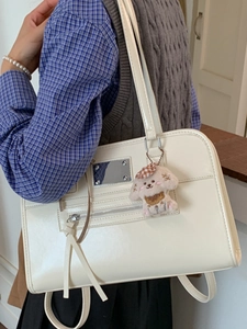 White glossy PU leather shoulder bag with a cute beige puppy plush pendant for women