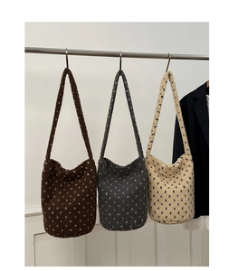 Detailed close-up of plush heart-patterned tote bags in brown, grey, and cream white colors