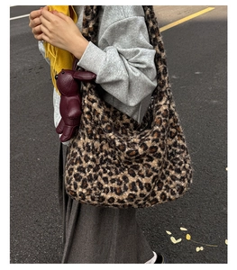 Close-up of leopard print faux fur tote bag featuring a cute purple rabbit charm detail
