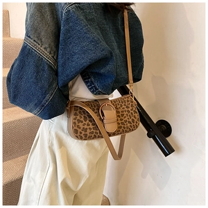 Leopard print baguette bag with gold metal buckle shown styled with a casual outfit