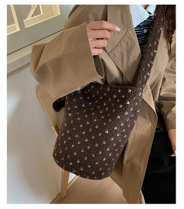 Detailed texture of brown plush tote bag with soft polka dots and warm fleece material