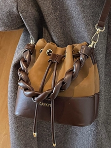 Minimalist vintage bucket bag with brown patchwork leather and braided handle detail