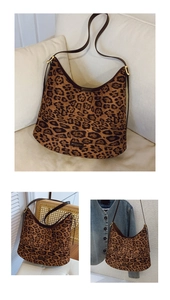Detail of leopard print tote bag with brown leather straps and gold-tone metal buckle
