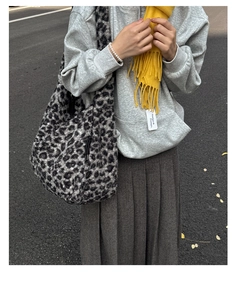 Fashionable large leopard print plush tote bag shown in an outdoor lifestyle setting