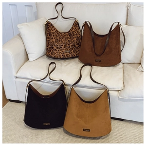 Detail showing four stylish suede bucket bags in leopard, coffee, black and camel colors