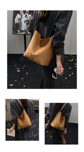 Detail of soft brown suede texture and sturdy stitching on large hobo shoulder tote bag