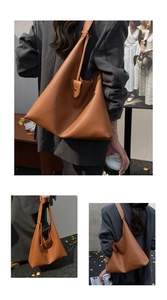 Close-up of brown litchi grain leather tote bag with stylish buckle and long shoulder strap