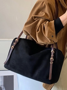 Minimalist black suede rectangular tote bag with brown leather straps and gold metal buckles