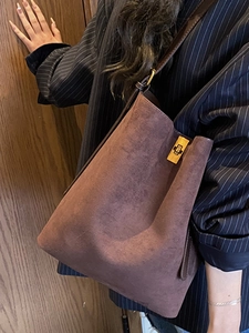 Brown suede tote bag with golden metal swivel clasp for elegant fashion commute style