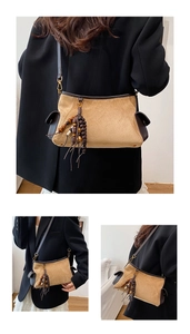 Detail of khaki suede shoulder bag with ethnic beaded tassel and brown leather accents