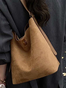 Brown suede tote bag with golden twist lock and adjustable strap for women in autumn