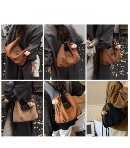 Three color options for the crescent shoulder bag featuring cute dog embroidery and charms