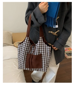 Grand sac cabas rétro à carreaux marron porté avec un manteau d'hiver élégant