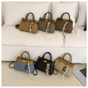 Detail of diverse handbag colors featuring leather and canvas textures with metal locks