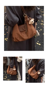 Detail of retro brown suede underarm bag featuring cute embroidery and plush bear charm