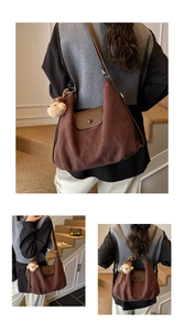 Detail of vintage brown suede hobo bag with cartoon embroidery and plush bear charm