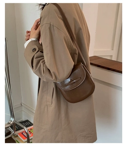 Retro brown PU leather crossbody bag with flap and strap shown on a model's shoulder