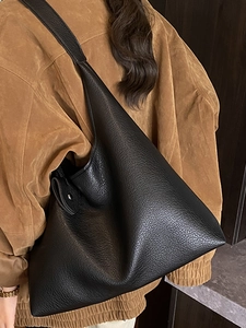 Chic black pebble grain leather tote bag with a minimalist triangle design for women