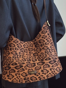 Large leopard print hobo bucket bag with leather strap and golden metal buckle for women
