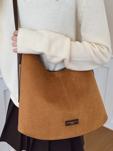 Brown suede-texture bucket bag with top stitching and crossbody strap for women