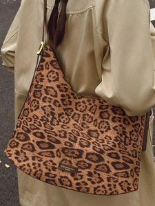 Chic leopard print large capacity bucket bag styled with a khaki trench coat for commute