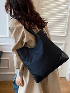Minimalist navy nylon tote bag with leather straps for women's daily commuting