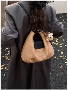 Brown suede tote bag featuring cartoon animal embossing and cute teddy bear pendant