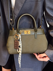 Olive green canvas and leather crossbody bucket bag with gold twist lock for women