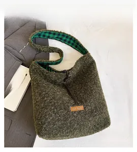 Detail of green fuzzy tote bag showing our fave tag and checkered lining texture
