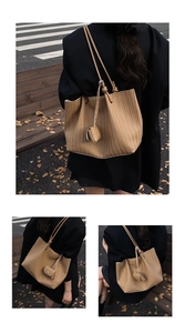Detail view of brown woven tote bag with shoulder strap and mini coin purse attachment