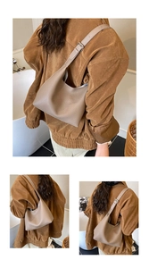 Detail view of adjustable strap and pebble grain leather texture on hobo shoulder bag