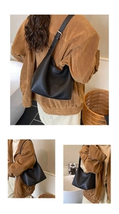 Detail of black pebbled leather Hobo shoulder bag with silver hardware and adjustable strap
