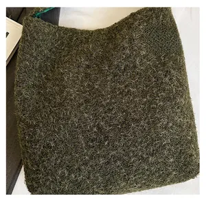 Close-up of fluffy dark green faux fur fabric with premium soft texture and inner lining